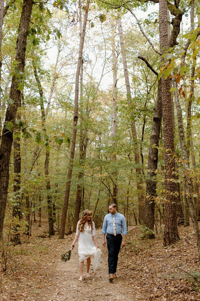 Bride and groom hiking on elopement wedding day near Tulsa 