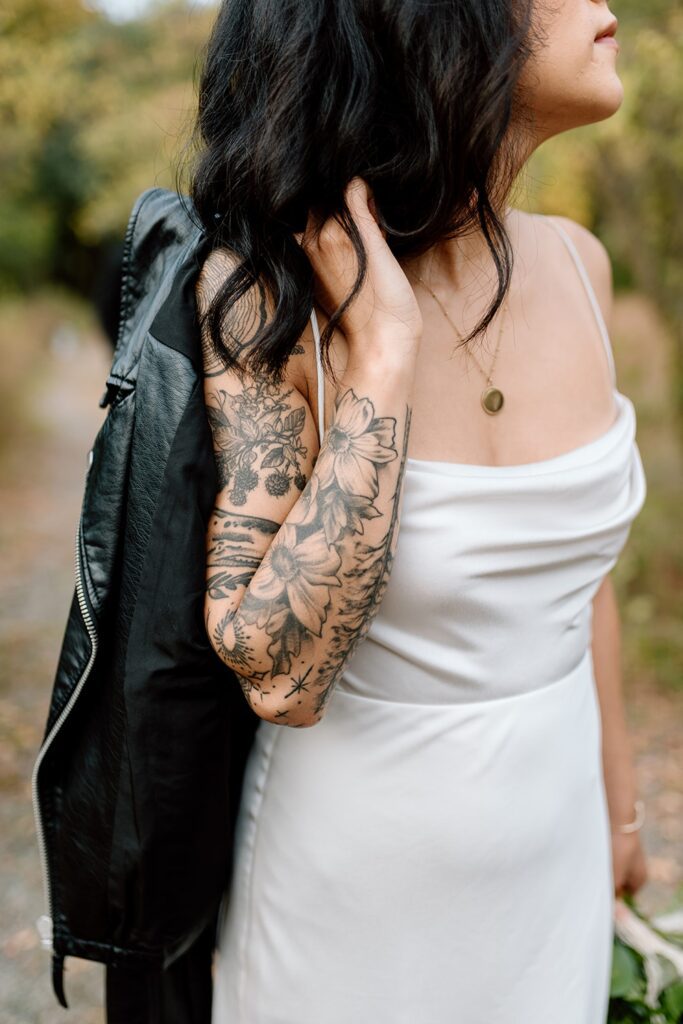 Bride with leather jacket and floral sleeve tattoo 
