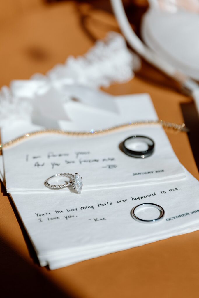 Flat lay detail photography with personal note and rings