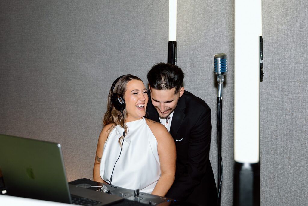 Couple in the DJ booth for The Vista at 21 wedding reception 