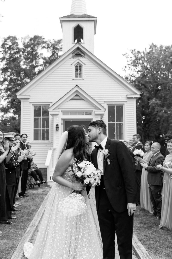 Intimate chapel wedding black and white photos of couple leaving wedding ceremony