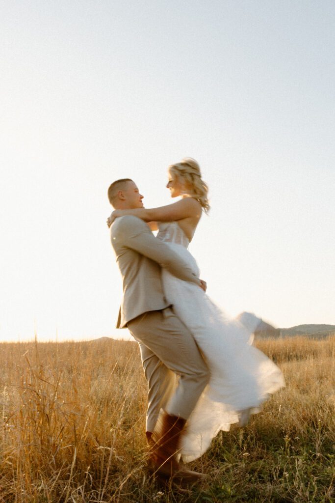 Groom twirling bride in Oklahoma state park
