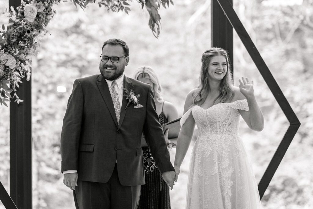 bride and groom whimsical ceremony arch 