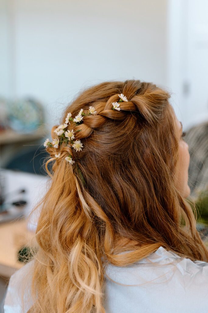 Brides hair in braids with flowers 
