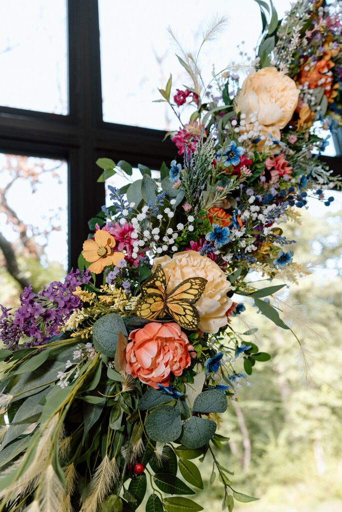 floral whimsical wedding arch with butterflies 