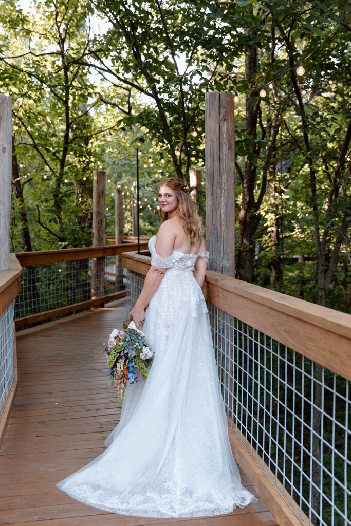 Bride on bridge in woods