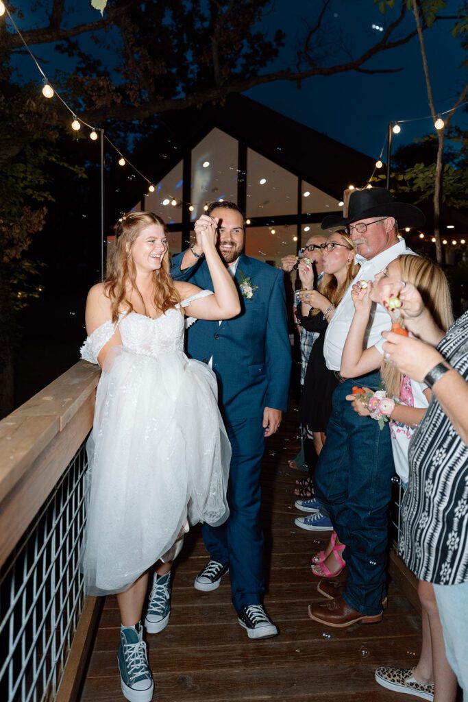 bride and groom grand departure under twinkle lights 