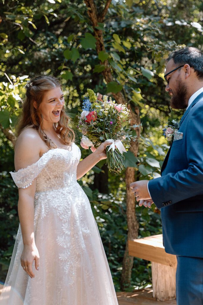 bride and groom first look in the woods 