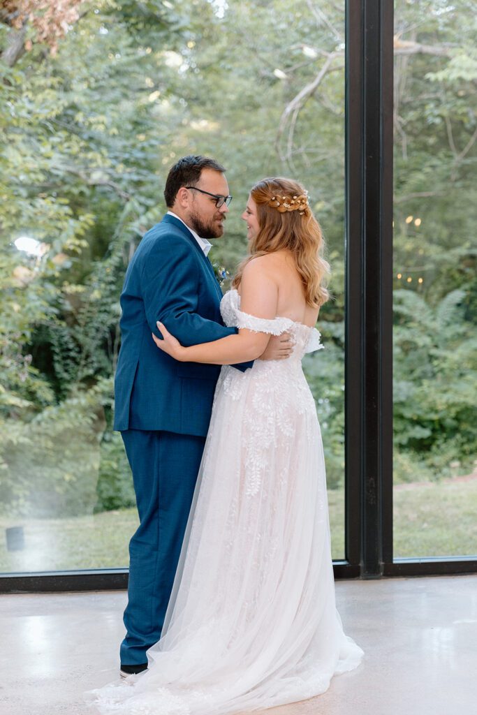bride and groom dancing with forest backdrop 