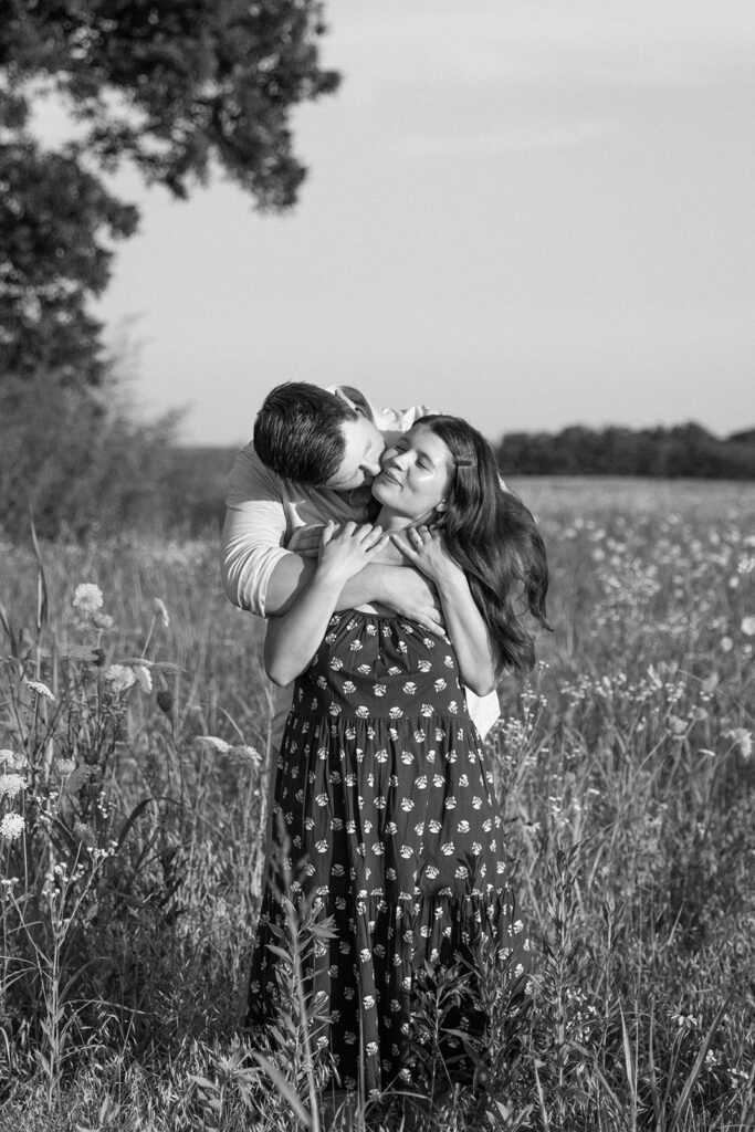 black and white image of couple in wildflowers 