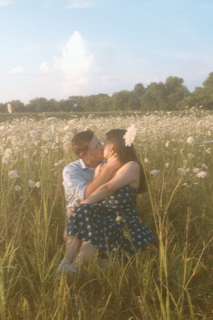 hazy picture couple kissing in wildflower field 