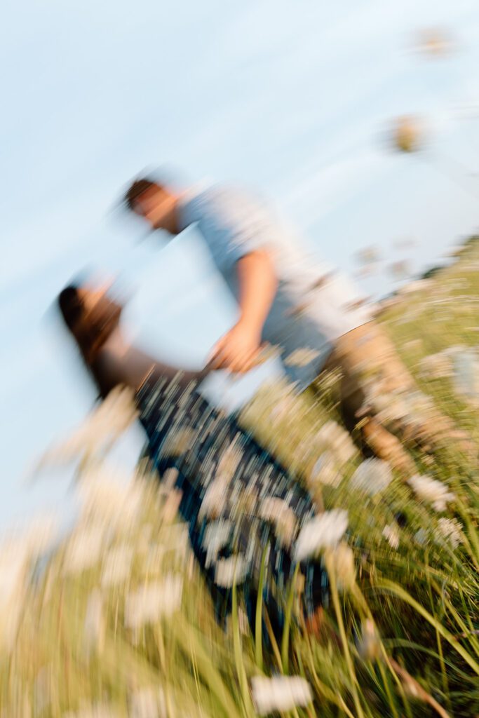 shaken picture of couple in wildflower field 