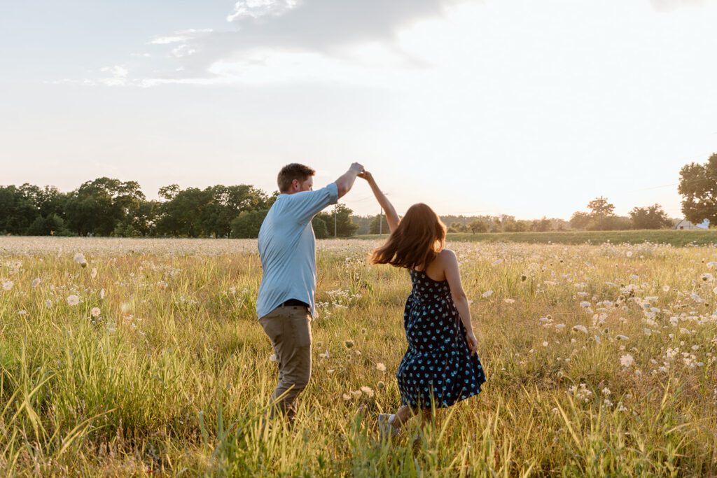 man and woman dancing in wildflower field 