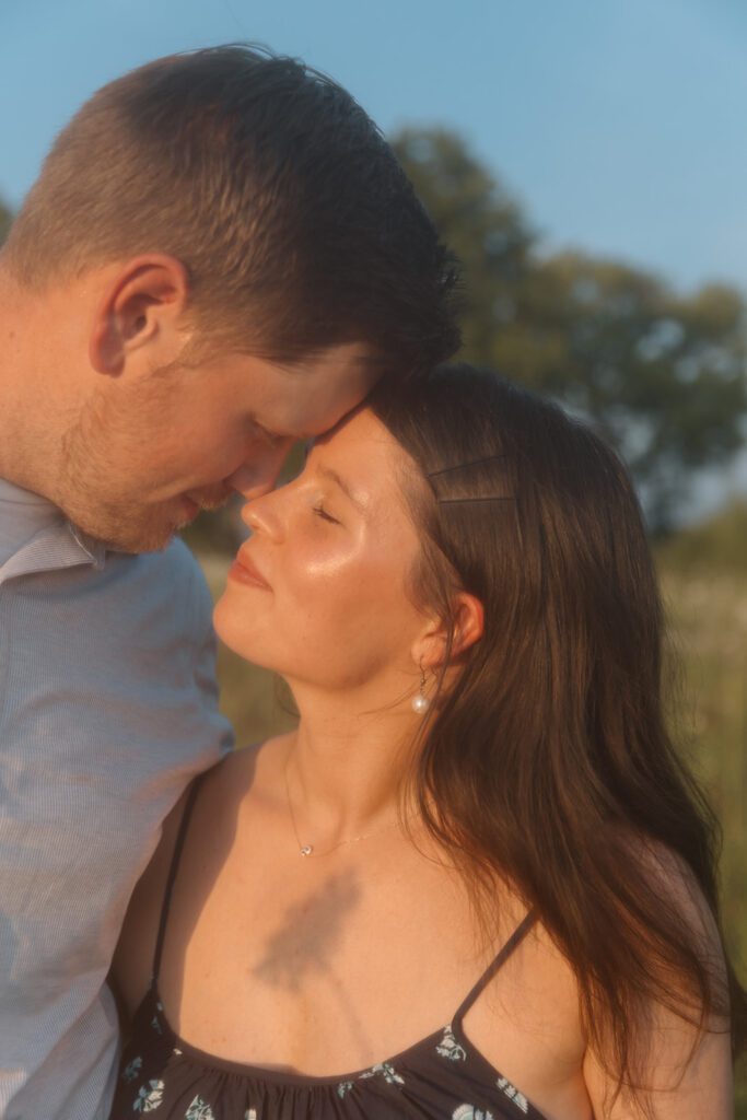 glowy couples shot with wildflower shadow golden hour wildflower engagement session