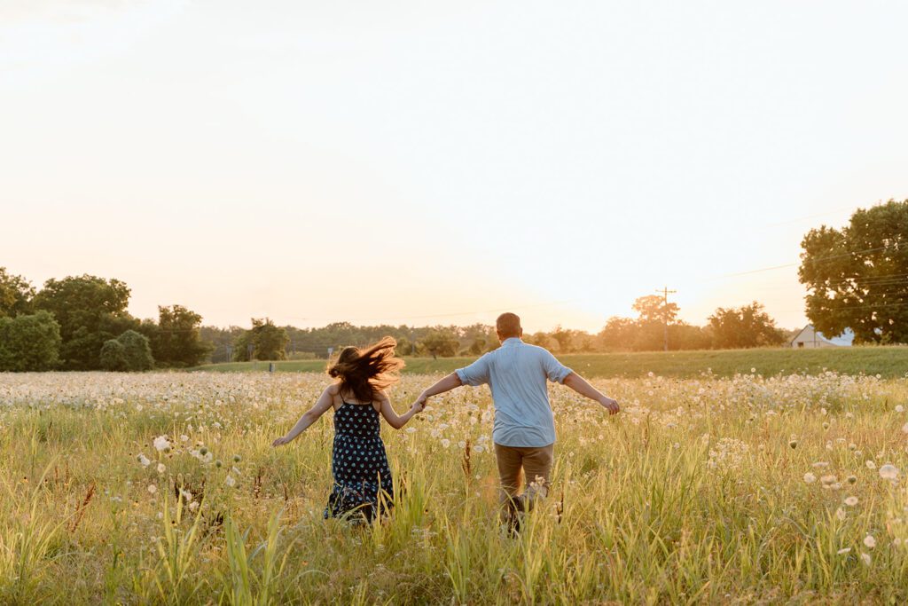 couple runs towards sunset in wildflower engagement session 