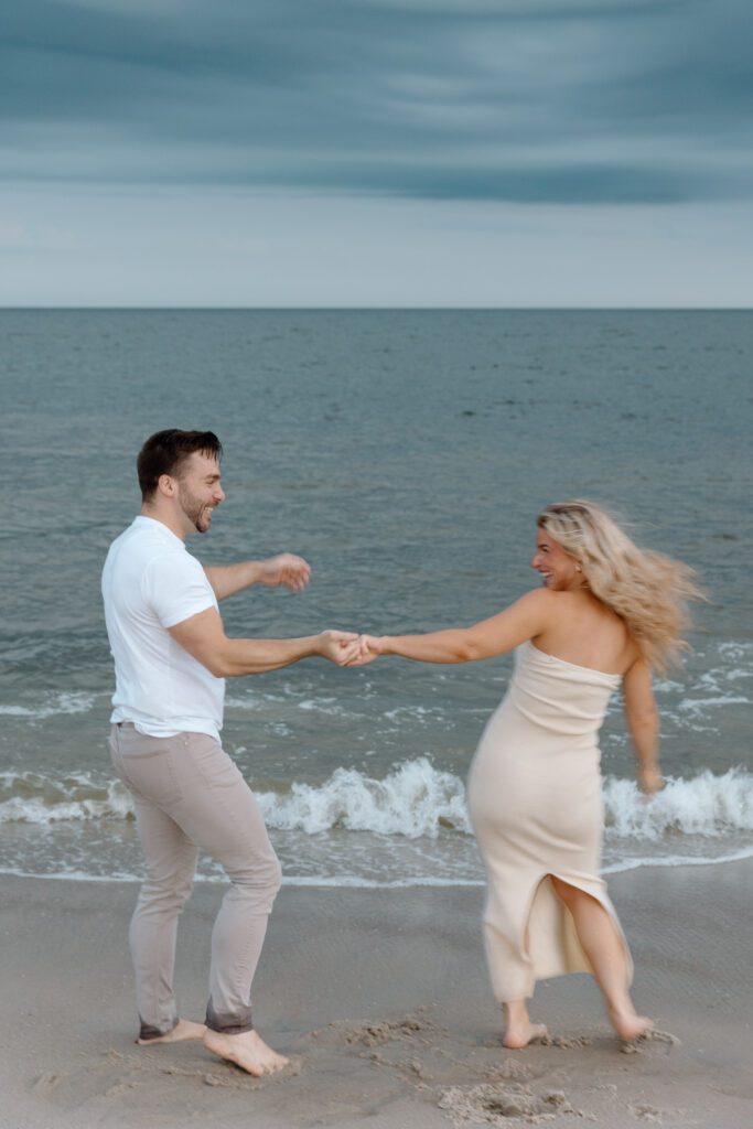 dancing couple in the waves sunset 