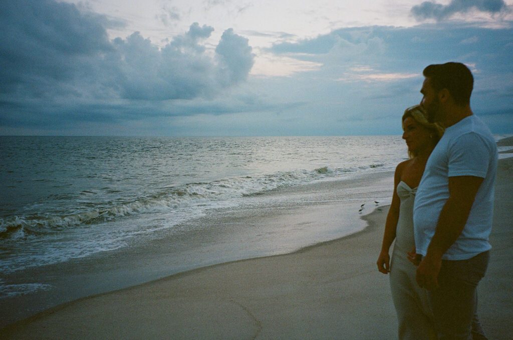 film sunset couple looking at ocean 