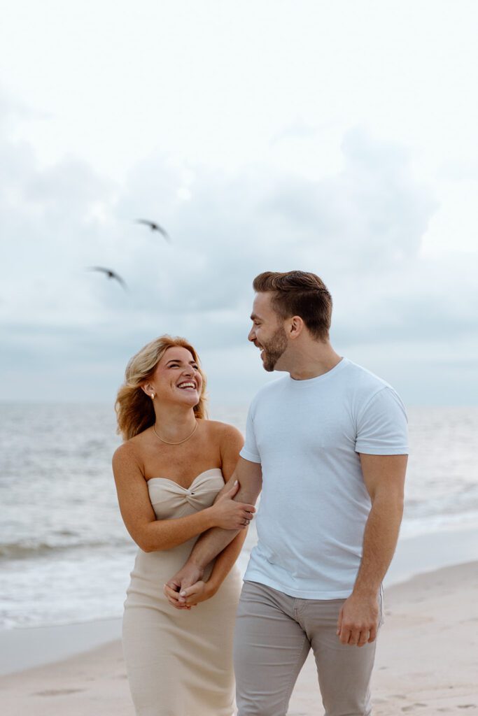 couple on the beach with seagulls 