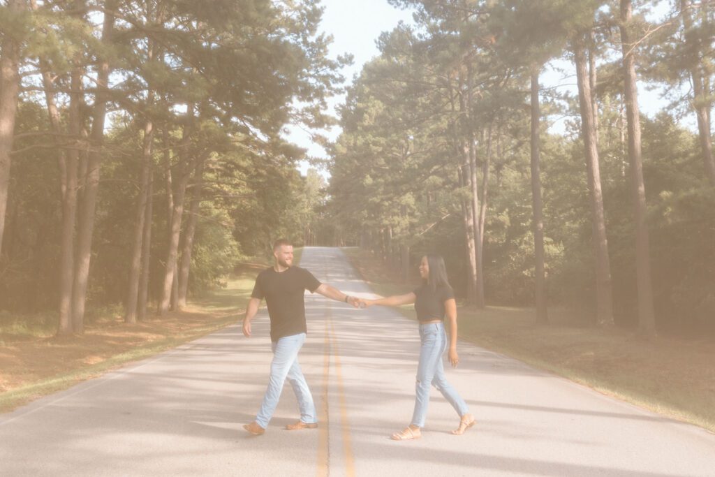 white man and black women holding hands and walking across the street 