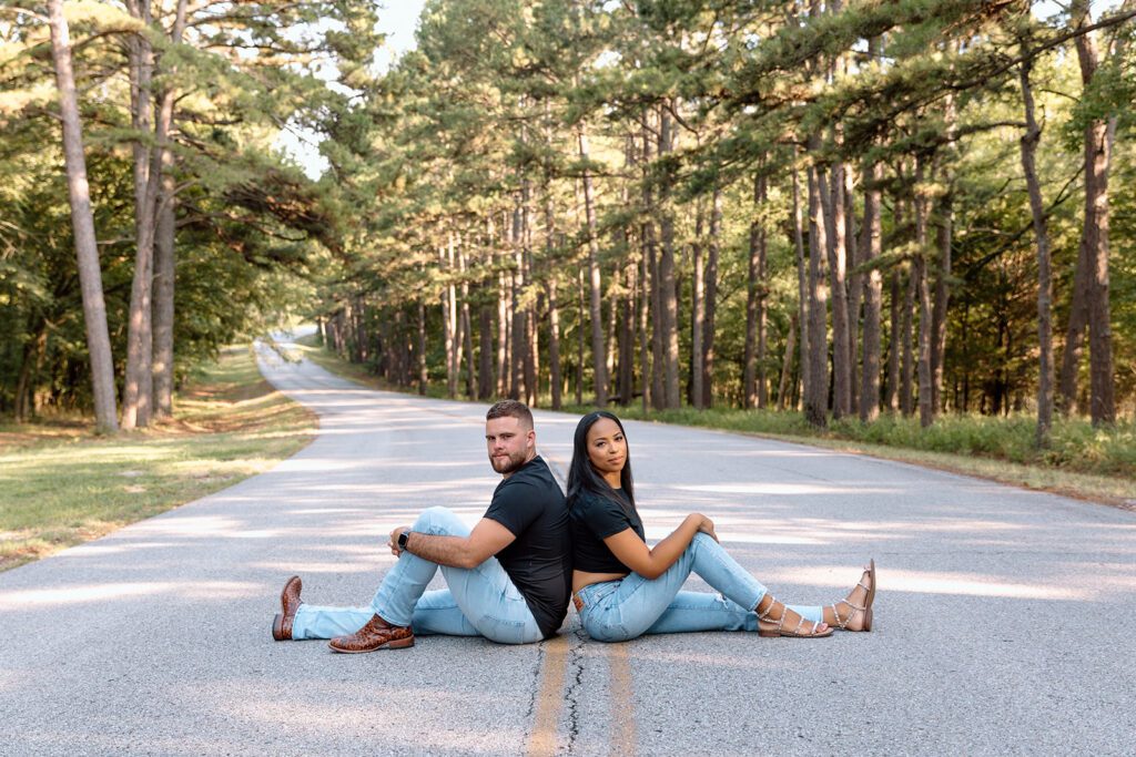 couple sitting on the road back to back 