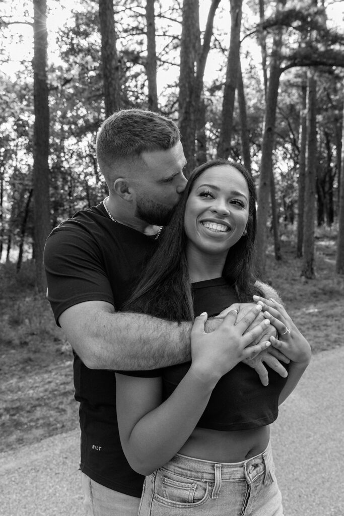 black and white image of couple in forest 