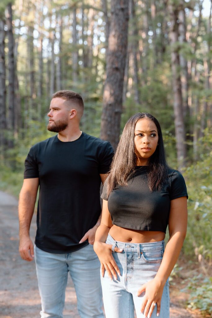 Couple in black shirts looking in opposite direction 