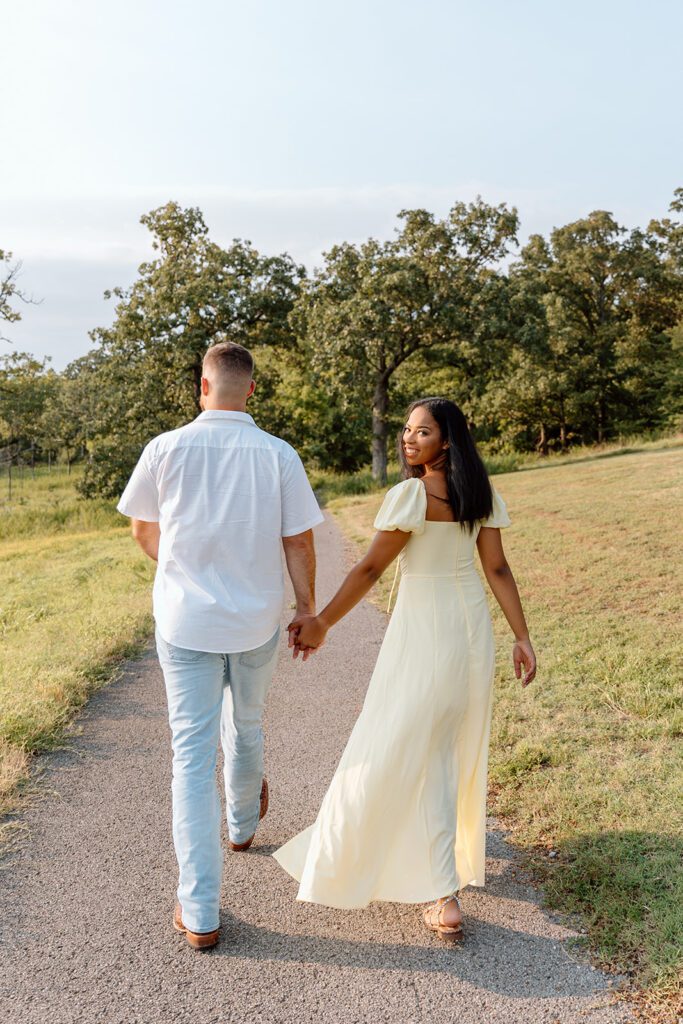 man and woman walk on path black woman looks back 