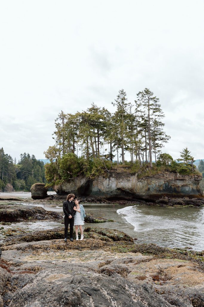 couple on rock during engagement session at Olympic State Park PNW