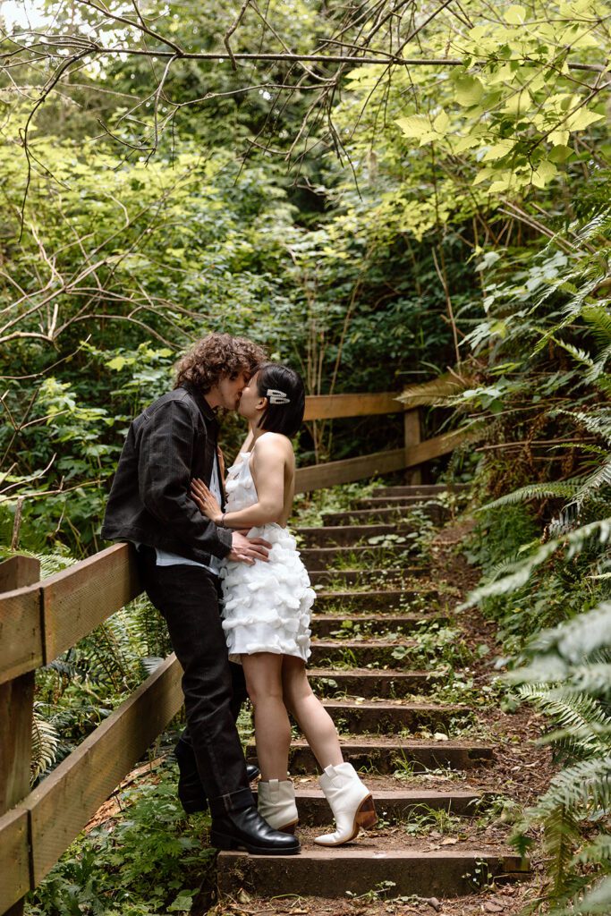 couple on steps in the forest engagement session at Olympic State Park