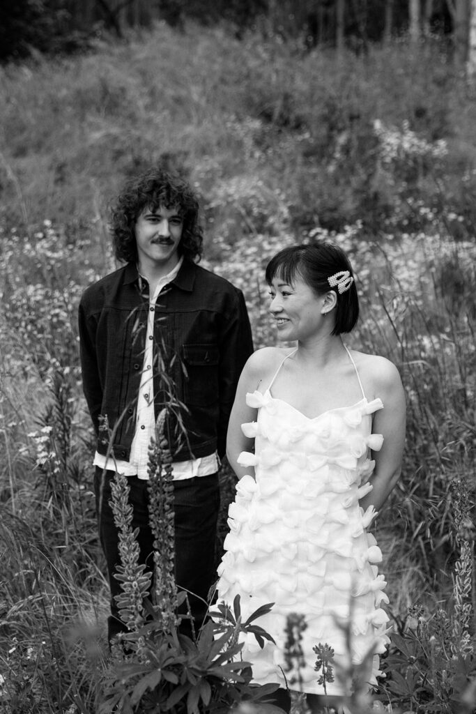 black and white couple walking through a meadow at olympic national park 