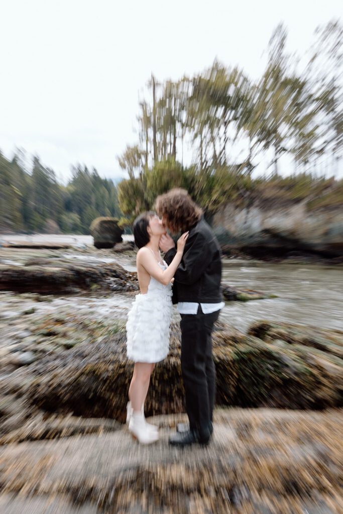 blurry image of couple kissing engagement session at olympic national park PNW