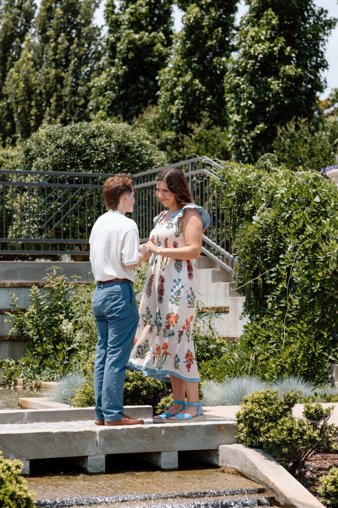 couple holding hands at queer engagement at Tulsa Botanical Garden