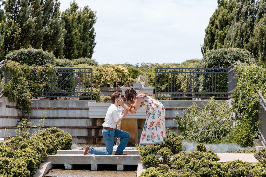 women kneeling proposing to a women at queer engagement at Tulsa Botanical Garden
