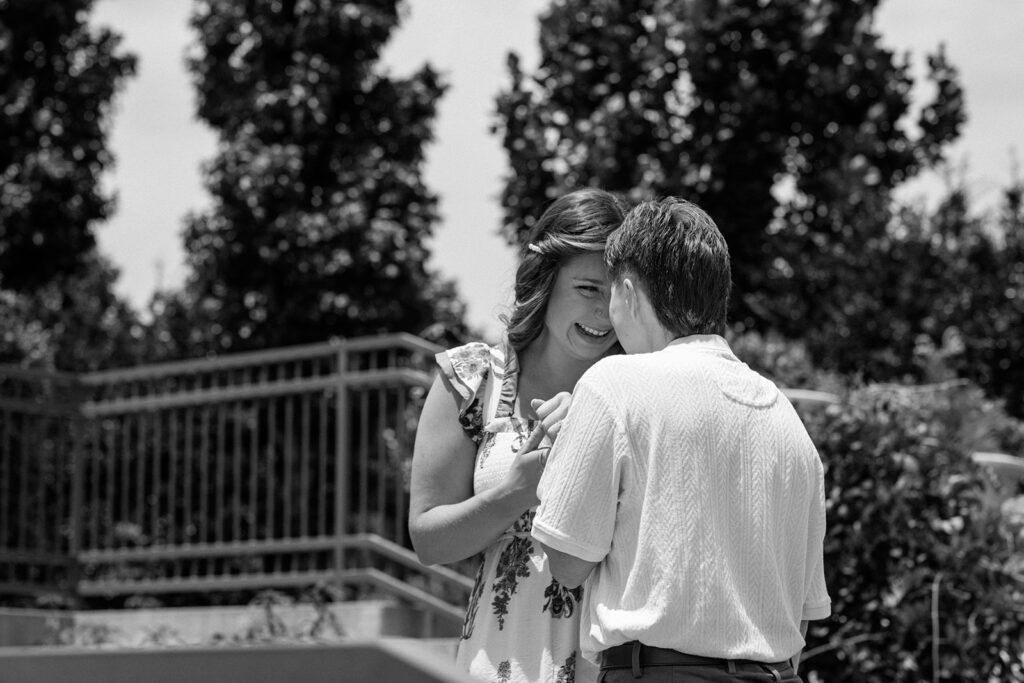 black and white picture of two women touching foreheads at queer engagement at Tulsa Botanical Garden