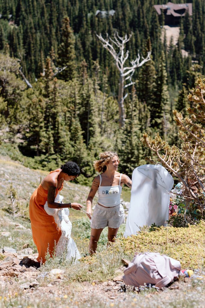 bride gets dressed for elopement at St. Mary's Glacier