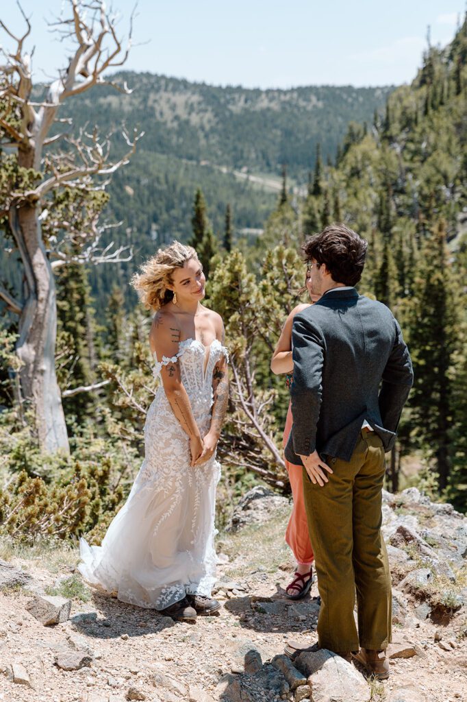 bride looks at groom at outdoor elopement in Colorado 