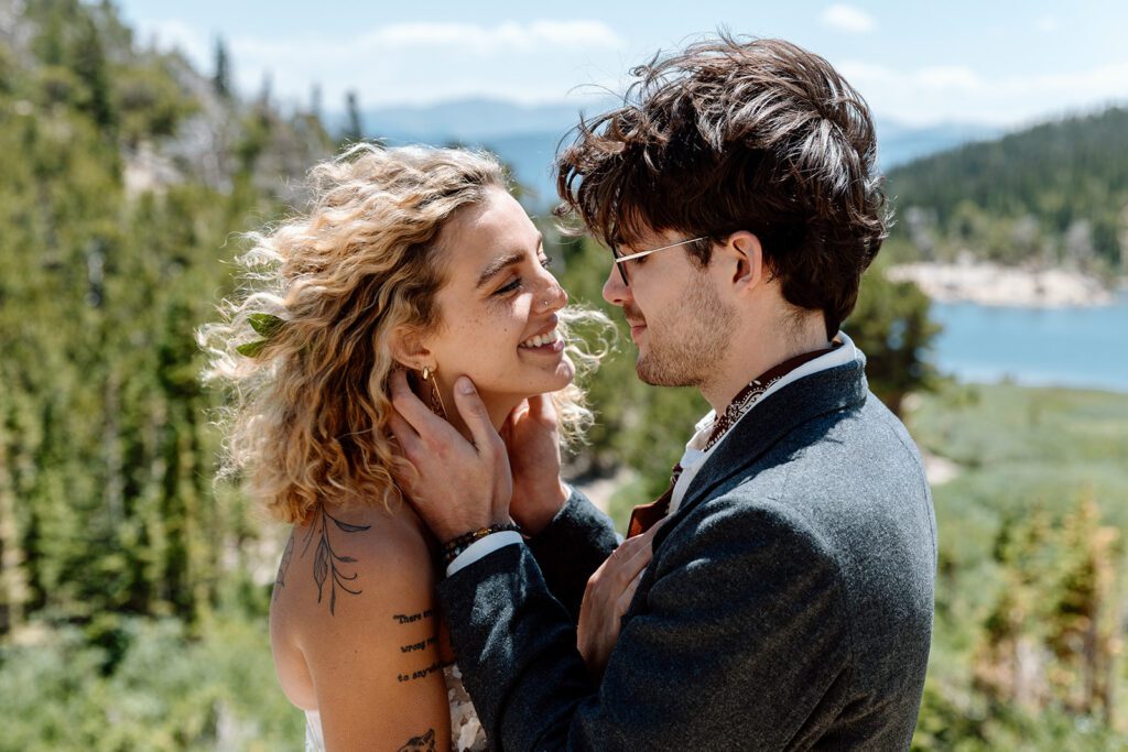 bride and groom look at each other on Colorado cliff 
