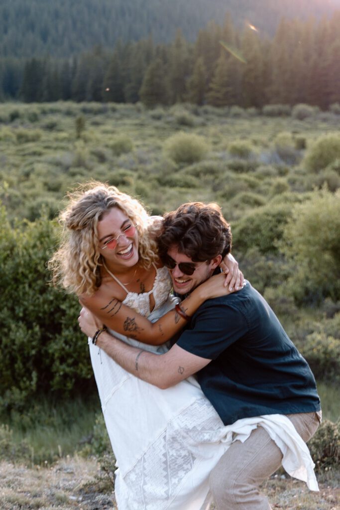 bride and groom mess around joking and having fun at Guanella Pass elopement in Colorado 