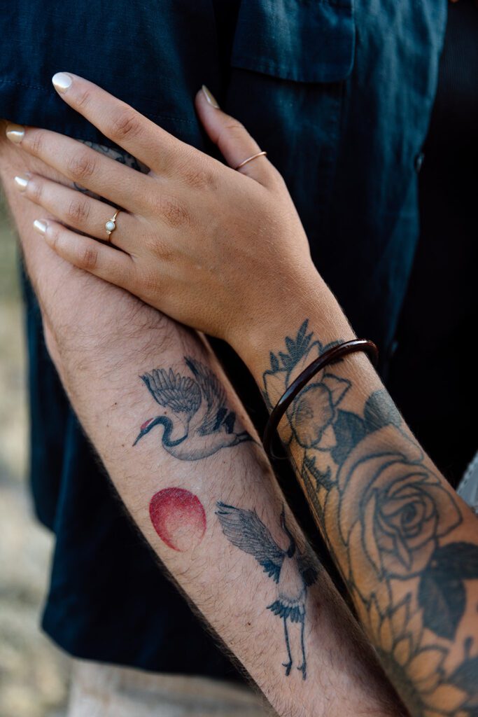 bride and groom shoe tattoos and hold arms 