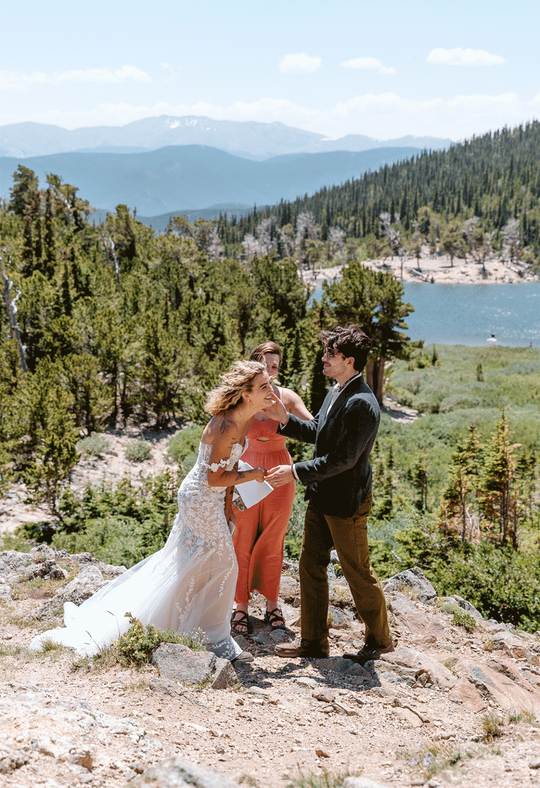 couple laughs during elopement on St. Mary's Glacier in Colorado 