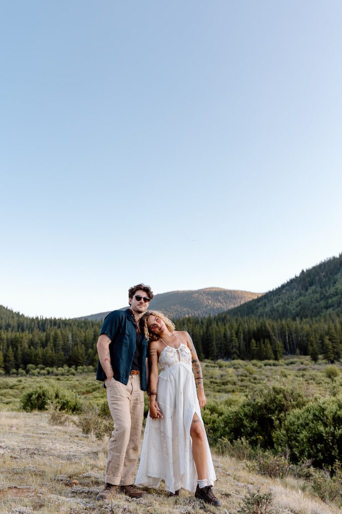 camping bride and groom pose for elopement picture 