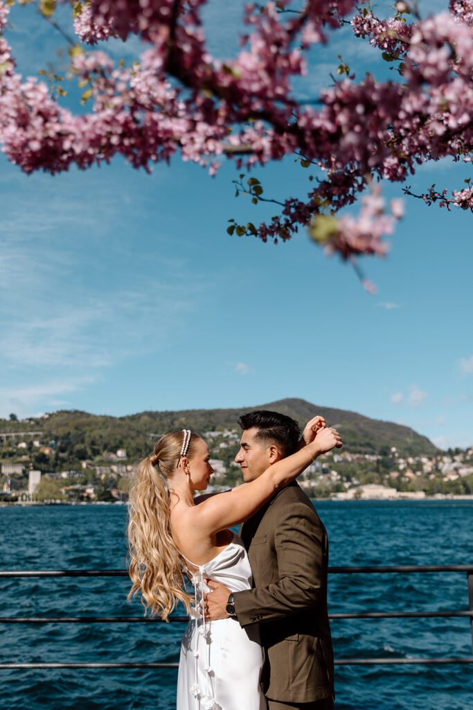 wedding couple embraces infront of lake como in spring 