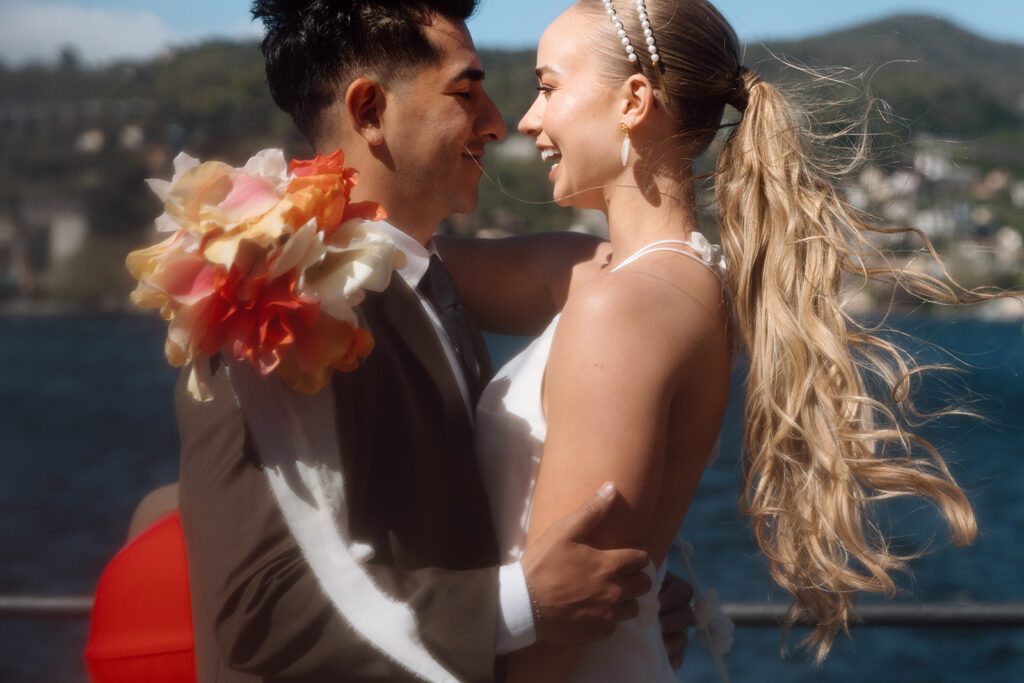bride laughs while groom holds her with tulip bouquet at Lake Como, Italy elopemnt 