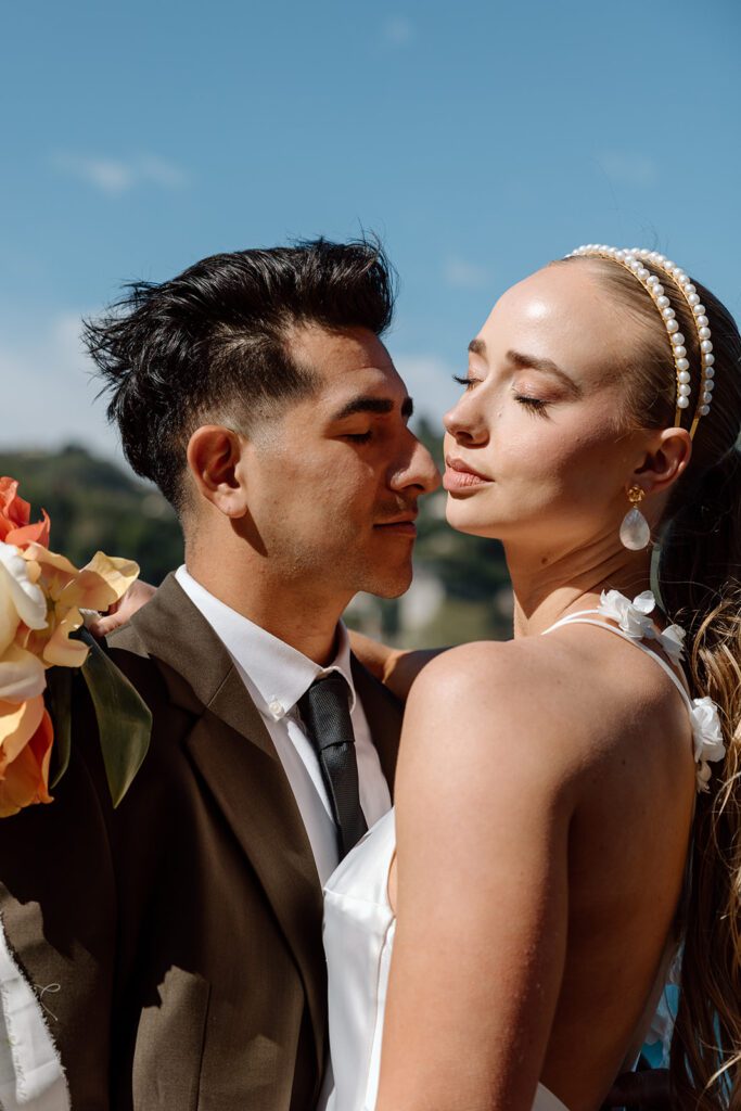 interrace groom and bride with eyes closed in sunlight at elopement 
