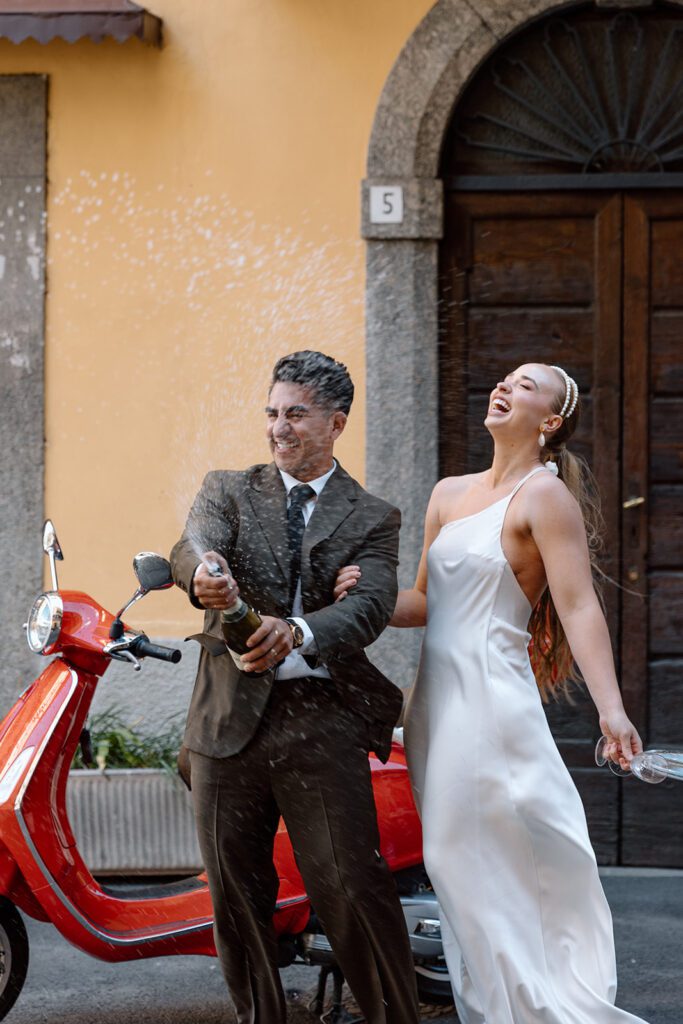bride and groom open champagne celebrate elopement in Italy 