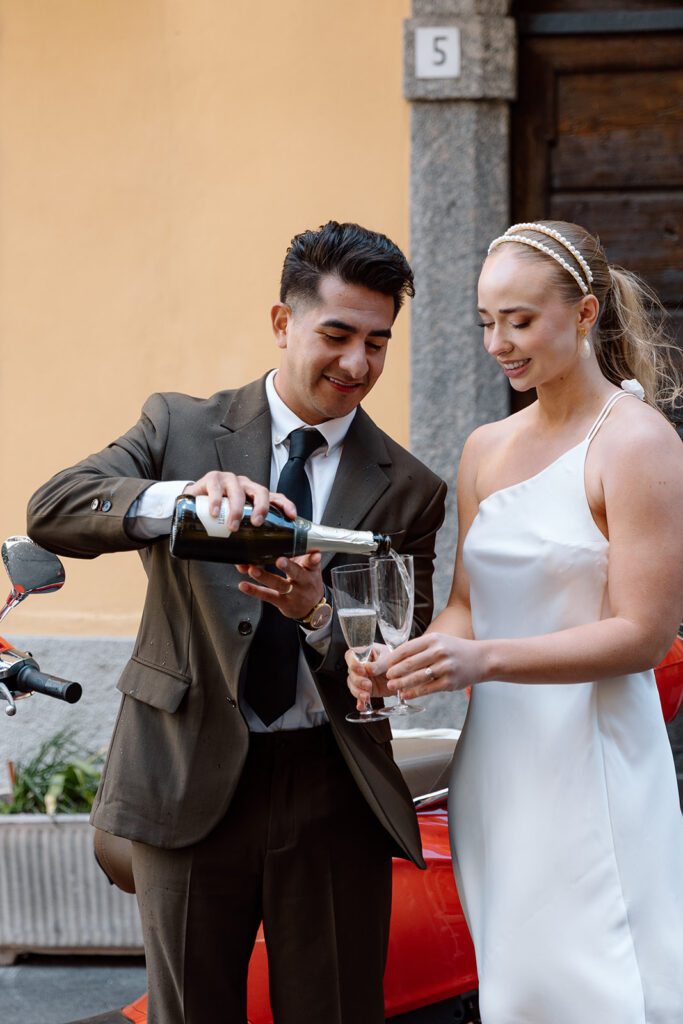bride and groom serve champagne in Lake Como elopement shoot 