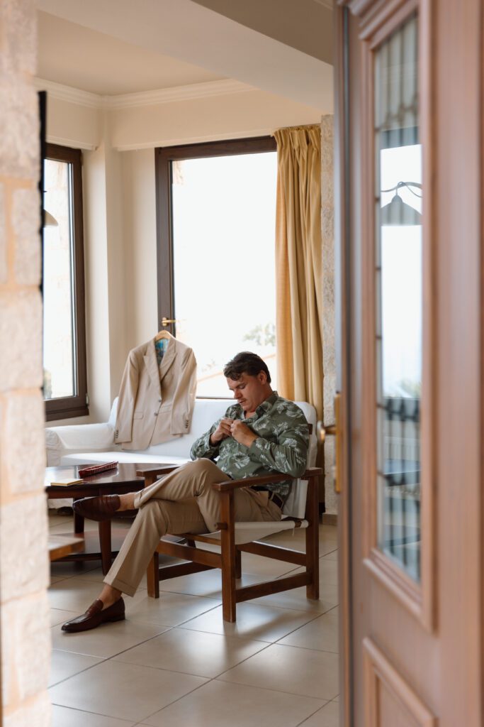 groom gets dressed for grecian elopement 