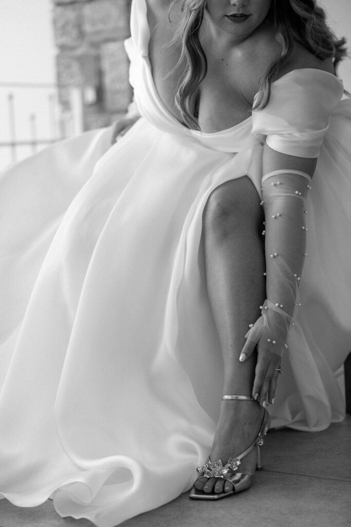 bride puts on shoes and pearl sleeve before eloping 