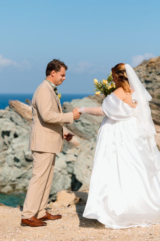 groom cries taking in bride in wedding dress in greece 