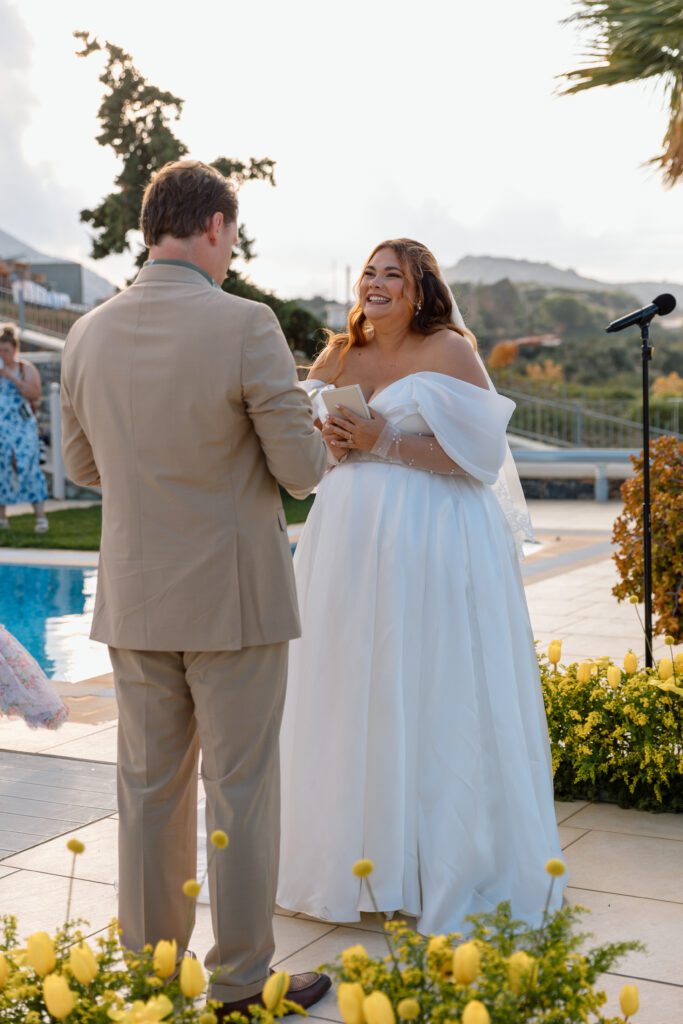 plus size bride reading vows to groom in tan suit 